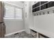 Mud room with patterned floor, white cabinets, storage baskets and hooks at 4586 Carefree Trl, Parker, CO 80134