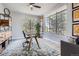 Bright home office with large windows and a modern glass desk at 4586 Carefree Trl, Parker, CO 80134