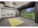 Recreation room featuring golf simulator, projector, and padded floor at 4586 Carefree Trl, Parker, CO 80134