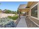 Backyard view with a covered patio, manicured landscaping, and a walkway leading to the house at 19753 E 54Th Ave, Denver, CO 80249