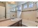 Bright bathroom with tub, shower, and mosaic tile accents at 19753 E 54Th Ave, Denver, CO 80249