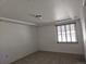 Well-lit bedroom featuring tray ceiling, neutral carpet, and a window with blinds at 19753 E 54Th Ave, Denver, CO 80249