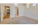 Bright bedroom with two windows, plush carpet, and a doorway to the bathroom at 19753 E 54Th Ave, Denver, CO 80249