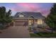 Inviting home featuring stone accents, a well-manicured lawn, and a spacious driveway for enhanced curb appeal at 19753 E 54Th Ave, Denver, CO 80249