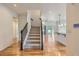 Foyer with hardwood floors, carpeted stairs, and an open-concept layout at 19753 E 54Th Ave, Denver, CO 80249
