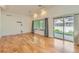 Spacious living room featuring hardwood floors, natural light, and sliding glass doors leading to the outdoors at 19753 E 54Th Ave, Denver, CO 80249