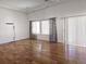 Bright living room with gleaming hardwood floors and large windows featuring decorative curtains at 19753 E 54Th Ave, Denver, CO 80249