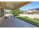 Comfortable covered patio featuring a beautiful green lawn, manicured landscaping, and a privacy fence at 19753 E 54Th Ave, Denver, CO 80249