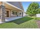 Spacious patio with stone supports, a manicured yard, and easy access to the home's interior at 19753 E 54Th Ave, Denver, CO 80249