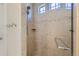 Modern tiled shower with dual shower heads, glass door, and tile accents at 19753 E 54Th Ave, Denver, CO 80249