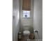 A clean, simple toilet situated next to a window for ample light at 19753 E 54Th Ave, Denver, CO 80249