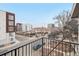 Apartment balcony has metal railings overlooking surrounding buildings and cityscape at 2162 S Ash St, Denver, CO 80222