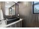 Modern powder room featuring bronze textured walls, black rectangular sink, and granite countertop at 2162 S Ash St, Denver, CO 80222