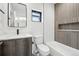 Cozy bathroom includes a shower and tub combo, gray-wood vanity, and framed mirror at 2162 S Ash St, Denver, CO 80222