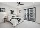 Modern bedroom featuring a balcony, neutral tones, a ceiling fan, and ample natural light at 2162 S Ash St, Denver, CO 80222