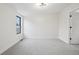 Empty room features a bright window, neutral carpet, and a modern light fixture at 2162 S Ash St, Denver, CO 80222