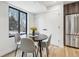 Cozy dining area with hardwood floors, modern table and chairs, and stainless steel refrigerator at 2162 S Ash St, Denver, CO 80222