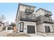 Contemporary three-story home featuring two balconies, light siding, and a one-car garage at 2162 S Ash St, Denver, CO 80222