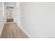 Clean and well-lit hallway with light wood floors, white walls, and doors leading to other rooms at 2162 S Ash St, Denver, CO 80222