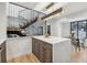 Bright kitchen featuring quartz counters, stainless appliances, and hardwood floors near the dining area at 2162 S Ash St, Denver, CO 80222