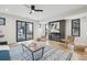 Well-lit living space with a modern fireplace, hardwood flooring, and access to an outdoor balcony at 2162 S Ash St, Denver, CO 80222