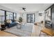 Bright living room with hardwood floors, modern fireplace, and sliding glass doors to a balcony at 2162 S Ash St, Denver, CO 80222