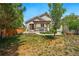 Expansive backyard featuring a pergola-covered patio, mature trees, and a well-maintained lawn at 16278 E 105Th Way, Commerce City, CO 80022
