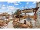 Backyard patio area with outdoor seating beneath a pergola, great for entertaining at 16278 E 105Th Way, Commerce City, CO 80022