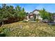 Spacious backyard with a covered patio, lush lawn, and mature trees, offering a perfect outdoor retreat at 16278 E 105Th Way, Commerce City, CO 80022