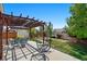 Relaxing backyard featuring a covered patio, stylish outdoor furniture, and lush green space at 16278 E 105Th Way, Commerce City, CO 80022