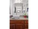 Bathroom featuring a vessel sink, granite counters, decorative mirror, and stylish backsplash at 16278 E 105Th Way, Commerce City, CO 80022