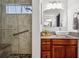 Well appointed bathroom with a glass enclosed shower with seat, and a vanity with vessel sink at 16278 E 105Th Way, Commerce City, CO 80022
