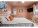 Bedroom with neutral colors, a large window, and sleek entertainment center perfect for relaxation and entertainment at 16278 E 105Th Way, Commerce City, CO 80022