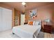 Cozy bedroom with soft carpet, stylish decor, including a decorative bird print, and an abundance of storage at 16278 E 105Th Way, Commerce City, CO 80022