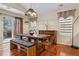 Bright dining room with a modern light fixture, wood floors, and sliding doors to the backyard at 16278 E 105Th Way, Commerce City, CO 80022
