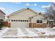 A one story home with a two car garage, and stone accents along the base of the exterior at 16278 E 105Th Way, Commerce City, CO 80022