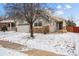 A charming single Gathering home with a two-car garage, set against a backdrop of fresh snow at 16278 E 105Th Way, Commerce City, CO 80022
