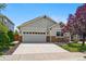 Inviting two-story home boasting a two-car garage, stone accents, and well-maintained landscaping for curb appeal at 16278 E 105Th Way, Commerce City, CO 80022