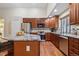 Spacious kitchen featuring stainless steel appliances, granite countertops, and wood cabinets at 16278 E 105Th Way, Commerce City, CO 80022