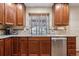 Kitchen featuring stainless steel dishwasher and sink with granite countertops at 16278 E 105Th Way, Commerce City, CO 80022