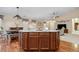 Kitchen island overlooking the dining and living areas with wood floors at 16278 E 105Th Way, Commerce City, CO 80022