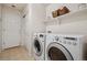 Efficient laundry room with modern washer and dryer, storage shelves and easy access to the exterior at 16278 E 105Th Way, Commerce City, CO 80022