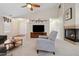 Cozy living room featuring a ceiling fan, fireplace and comfortable seating at 16278 E 105Th Way, Commerce City, CO 80022