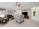 Open-concept living room with a ceiling fan, a modern light fixture, and a television at 16278 E 105Th Way, Commerce City, CO 80022