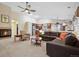 Bright living room with a fireplace, a large sectional sofa, and view of the kitchen at 16278 E 105Th Way, Commerce City, CO 80022