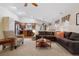 Open-concept living room with a large sectional sofa and view of the kitchen, perfect for entertaining at 16278 E 105Th Way, Commerce City, CO 80022