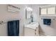 Charming bathroom with marble countertop, towel rack, and framed mirror at 3150 W Stanford Ave, Englewood, CO 80110