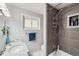 Modern bathroom with tiled shower, marble countertop, and ample lighting at 3150 W Stanford Ave, Englewood, CO 80110