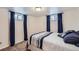Bright bedroom with two windows, curtains, and plush carpeting at 3150 W Stanford Ave, Englewood, CO 80110