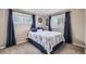 Cozy bedroom with two windows, blue curtains, and plush carpeting at 3150 W Stanford Ave, Englewood, CO 80110
